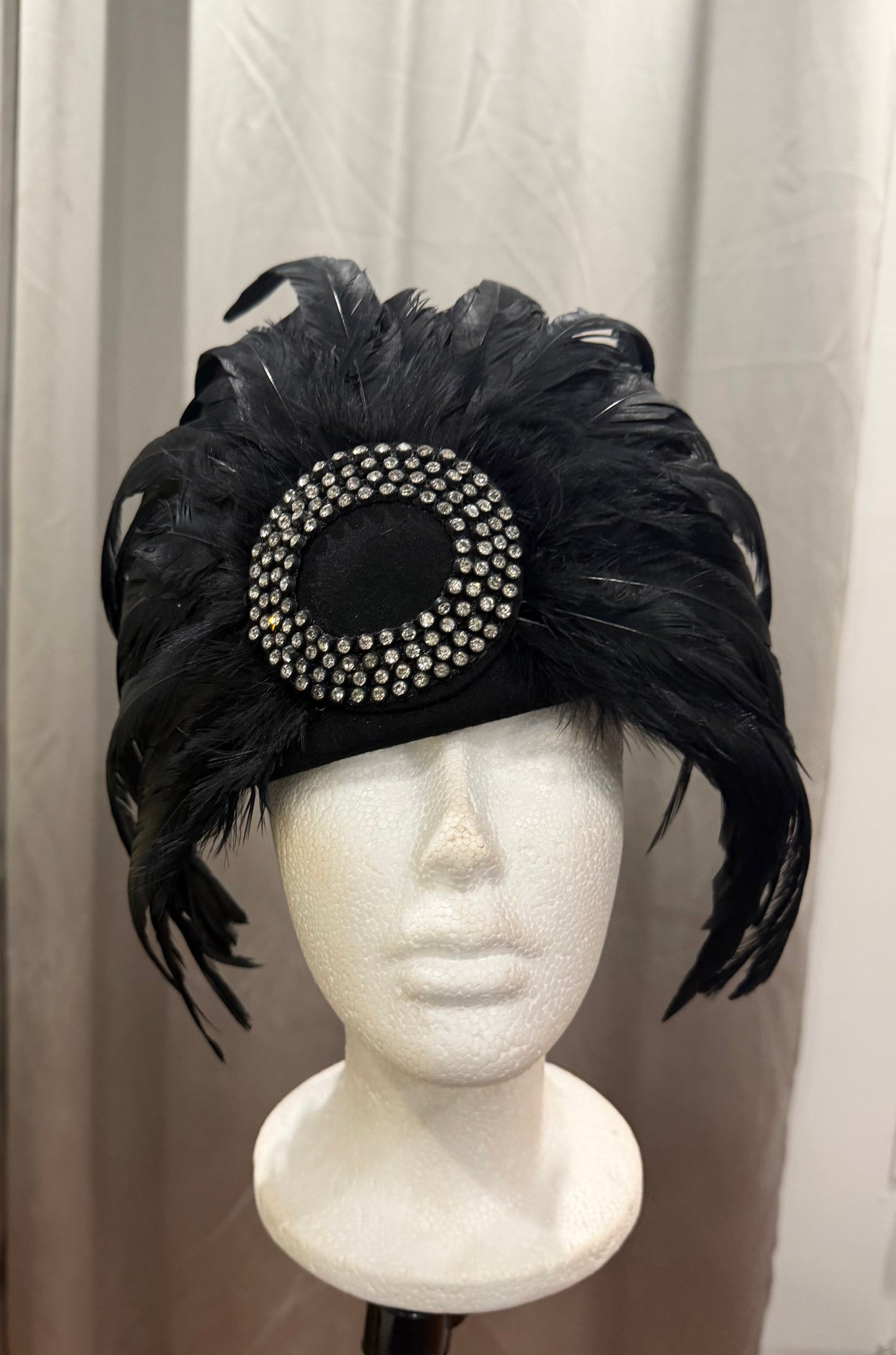 Black Feathered Hat with Decorative Elements